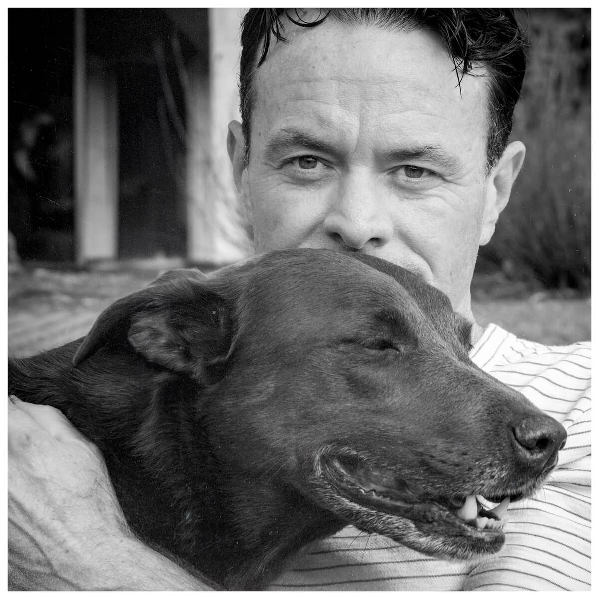 Douglas Keane emrbacing his dog Roxie