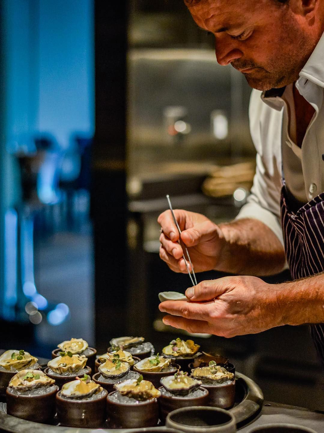 Chef Douglas Keane preparing oysters